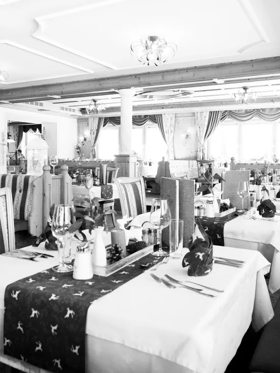 Elegant restaurant dining area with decorated tables and striped upholstered chairs